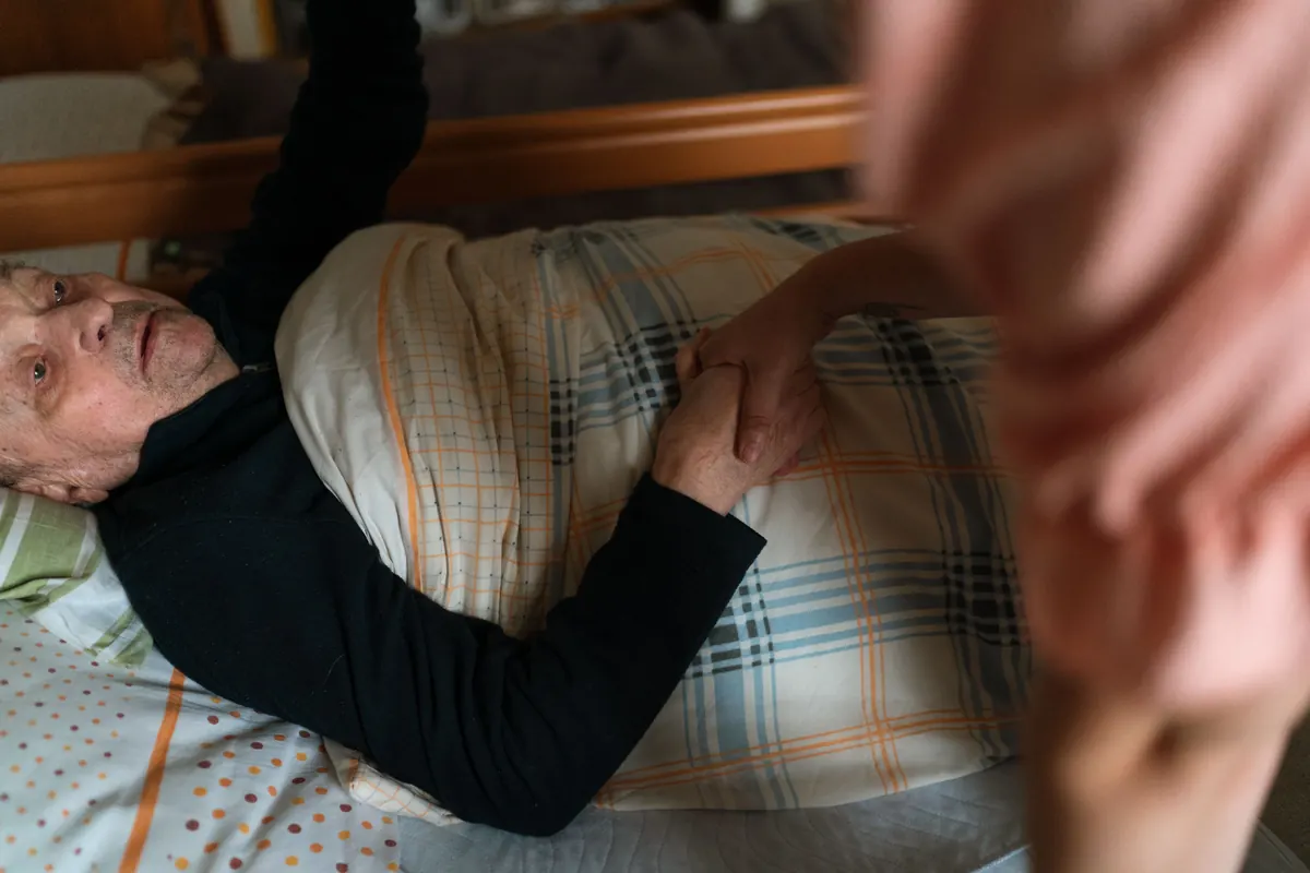Caregiver holding hands with a senior adult